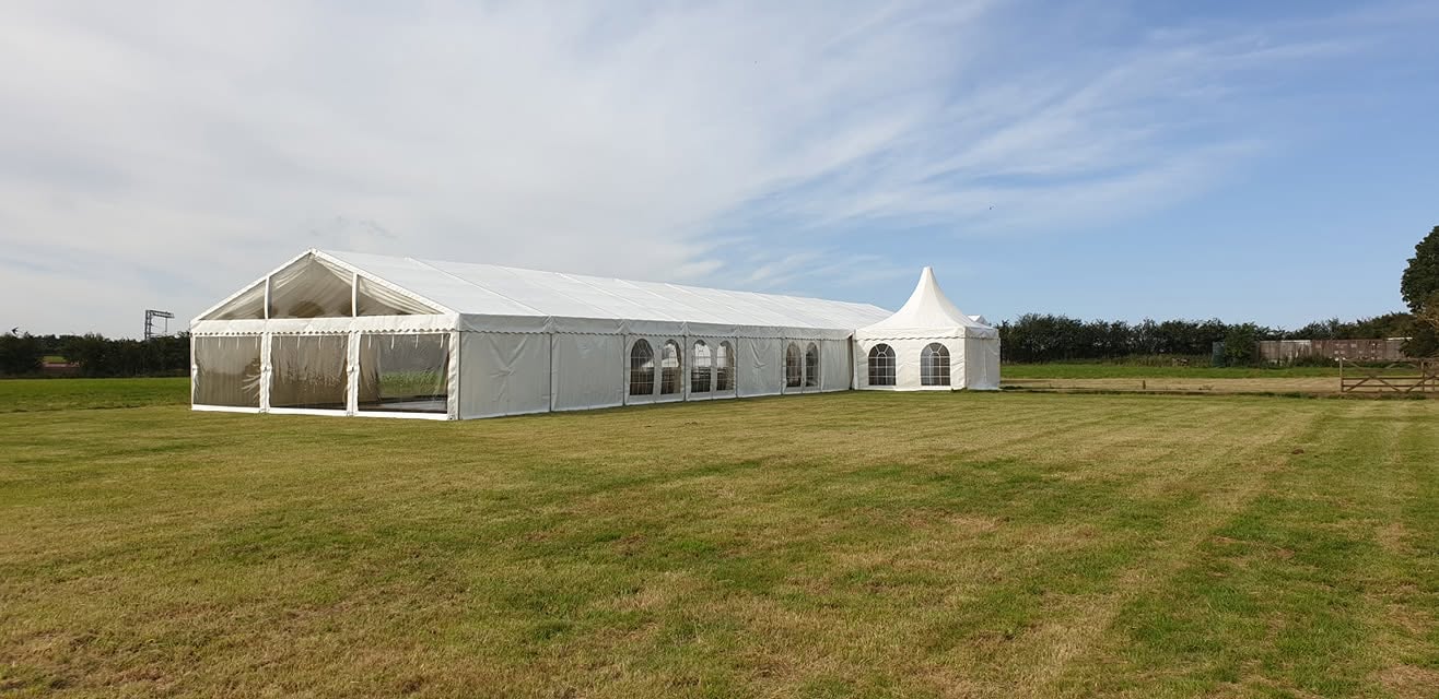 Marquee hire in open field for outdoor event